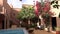 Swimming pool in courtyard in traditional Moroccan riad with clay houses in arabian design and trees with flowers