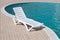 Swimming pool and empty resting chair