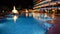 The swimming pool with fountains in night illumination