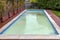 A swimming pool has white water due to shock chlorination