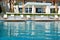 Swimming pool with jacuzzi by beach at the modern luxury hotel