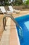 Swimming pool ladder and sunloungers