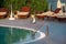 Swimming pool of luxury holiday hotel, amazing view and scene of seagull enjoying alone. Relax near pool with handrail, sunbeds.
