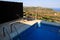 Swimming pool of luxury holiday villa, amazing nature view landscape sea. Relax near swimming pool with handrail, deck chairs.