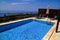 Swimming pool of luxury holiday villa, amazing nature view landscape sea. Relax near swimming pool with handrail, deck chairs.