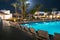 Swimming pool at night in one of the hotels near beach. Beautiful view of the luxurious hotel pool in the moonlight. Rest area at