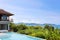 Swimming pool overlooking view andaman sea mountains and blue sk