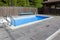 Swimming pool, patio area and barbecue gazebo in backyard of country house