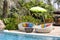 Swimming pool and rattan daybeds in a tropical garden, Thailand