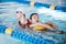 Swimming pool rescue, or woman with lifeguard for help in emergency, drowning accident or dangerous event. Fitness