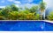 Swimming pool in resort with blue sky background, resort hotel landscaping concept.
