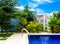 Swimming pool in resort with blue sky background, resort hotel landscaping concept.