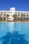 Swimming pool in Spanish hotel with palm trees