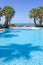 Swimming pool in Spanish hotel with sea views and palm trees