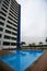 Swimming pool, sun loungers next to the garden and condo