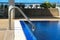 Swimming pool with sunny reflections on good weather day. Relax time with family on swimming pool. Popular sport