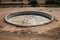 swimming pool surrounded by dried earth, symbolizing drought and water scarcity