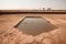 swimming pool surrounded by dried earth, symbolizing drought and water scarcity