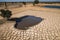 swimming pool surrounded by dried earth, symbolizing drought and water scarcity