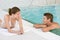 Swimming pool - young happy couple relax