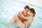 Swimming pool - young loving couple have fun