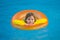 Swimming, summer vacation. Child swim in pool on inflatable ring. Kid with inflatable ring in swimming pool. Summer