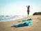 swimsuit in the sand on the beach near the sea surf on the background of a naked female figure and blue sky