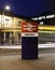 Swindon Railway Station Sign in Wiltshire at night with light trails from a passing bus