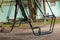 Swing for children abandoned in a park in autumn in ukraine in the city of dnipro