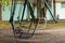 Swing for children abandoned in a park in autumn in ukraine in the city of dnipro