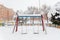Swing covered in snow in urban area