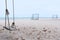 A swing and soccer goal on the beach