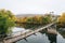 Swinging bridge over the James River and fall color in Buchanan, Virginia