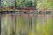 Swinging bridge water reflections.