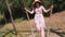 swinging. Happy young woman, in sunglasses and hat, having fun swinging on a big wooden swing, in the park, sunny summer