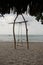 Swinging Serenity: Wooden Swing by Lombok\\\'s Tranquil Shore