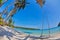 Swings and palm on the sand tropical beach