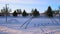 A swingset in a snowed over playground