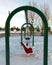 A swingset in a snowed over playground