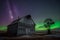 Swirl of bright northern lights over vintage barn, bins, windmill and stubble created with Generative AI technology