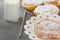 Swirl Danish Pastry Powdered on Cooling Rack and Cake Stand. Bottle of Milk Striped Straw.