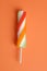 Swirl popsicle on orange paper background