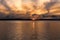 Swirling cloud golden hour over water