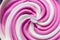 Swirling pink Italian ice cream with a ridged pattern background