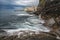 Swirling surf on the rocky coastline Bogliasco