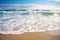 swirling waves on a sandy ocean beach