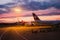 Swiss airline airplane parked in airport during dramatic cloudy summer sunset as seen from inside plane