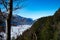 Swiss Alps high above Walensee: A coniferous forest and a vally full of fog