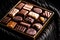 Swiss chocolates in gift box, various luxury pralines made of dark and milk organic chocolate in chocolaterie in