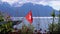 Swiss flag on a background of alpine mountains and flowers near Lake Geneva